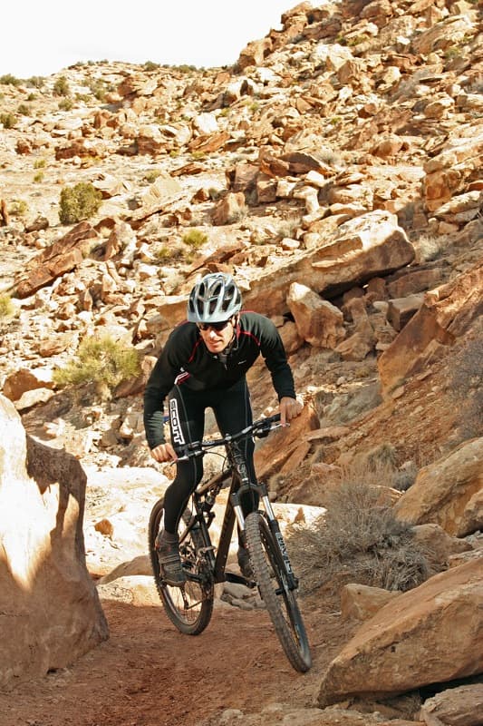 Illustrative photo of a cross-country mountain biker on a trail; not a photo of this venue.
