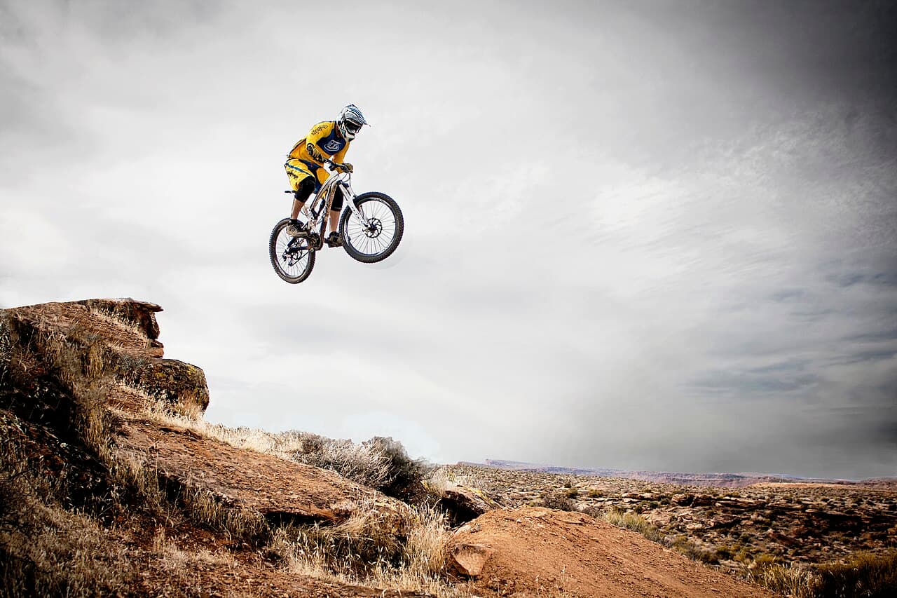 Illustrative photo of a mountain biker jumping on a trail; not a photo of this venue.
